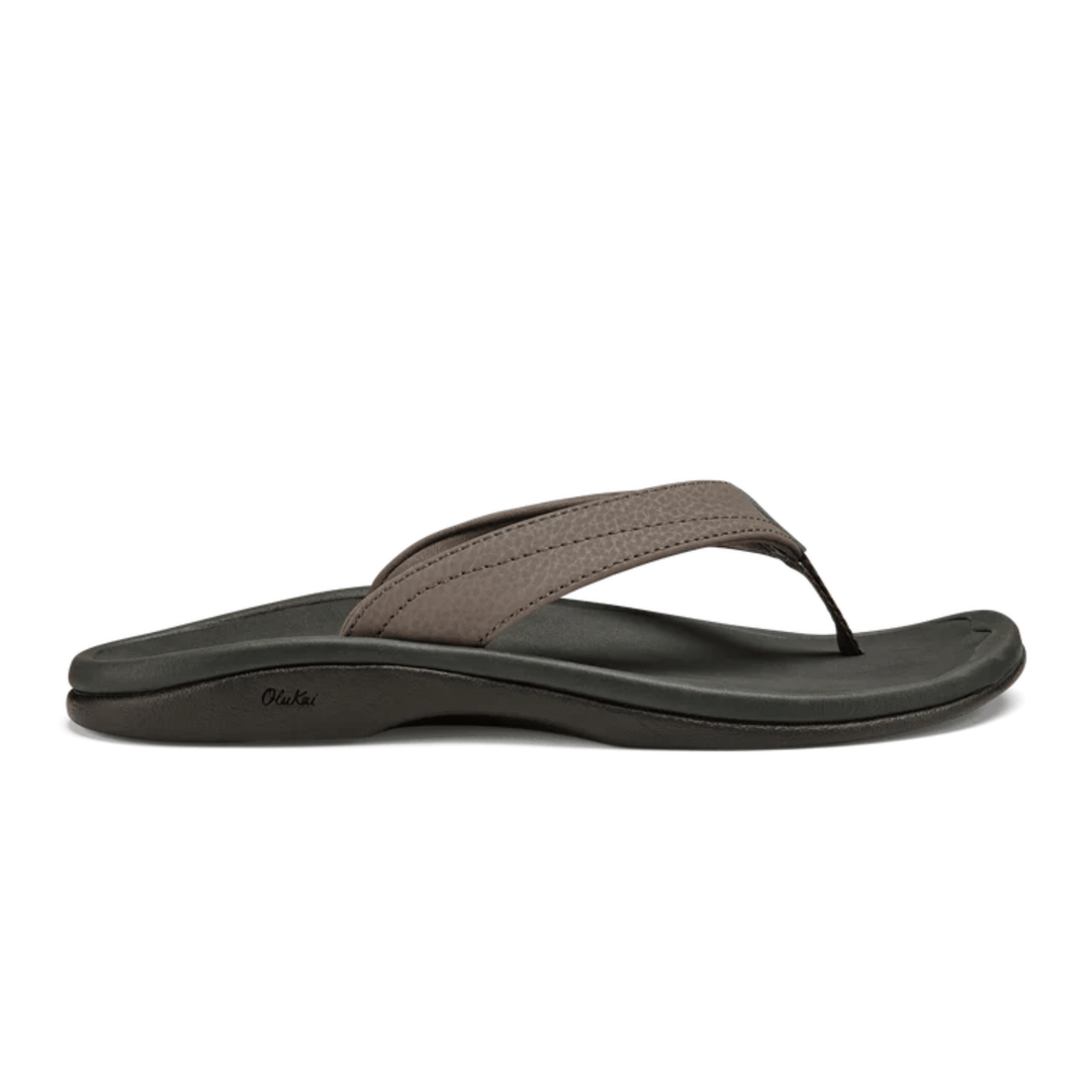 Thong sandal with dark gray footbed, taupe strap, and OluKai logo