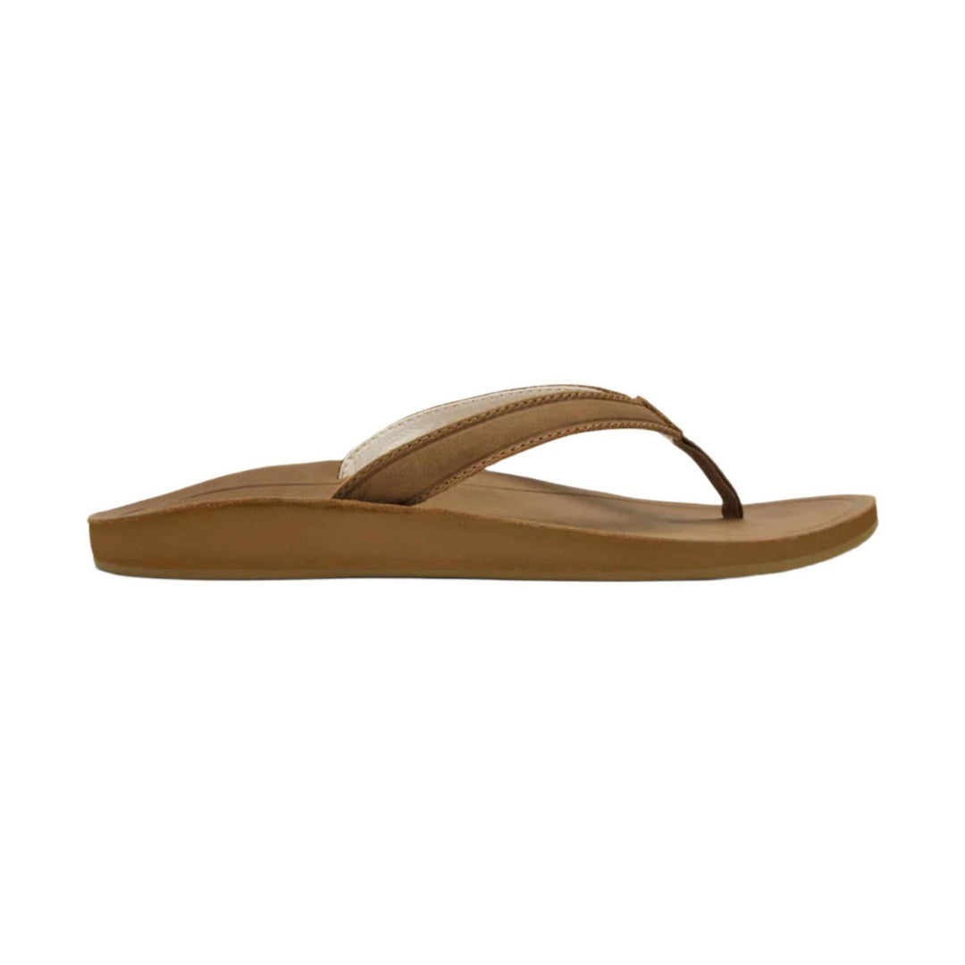 Tan thong sandal with a low wedge sole and crisscross leather straps