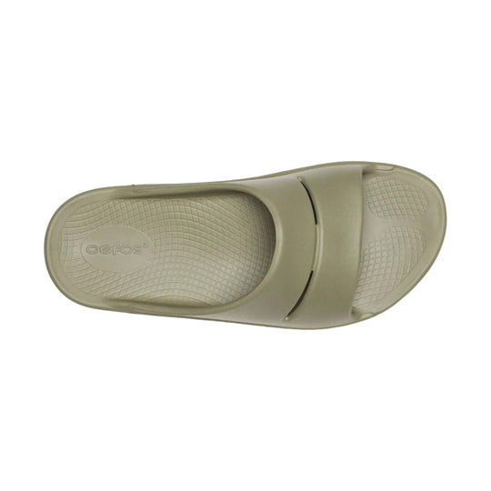 Beige slip-on slide sandal with textured footbed and molded strap, top view
