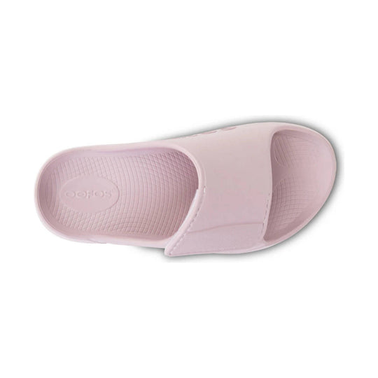 Light pink slide sandal with a textured footbed and embossed logo