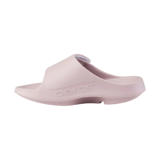 Light pink slide sandal with a contoured footbed and embossed OOFOS logo