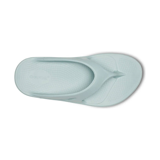 Light mint rubber flip flop with a textured footbed and embossed logo