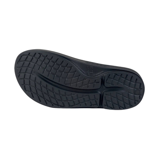Black slip-on sandal outsole with a textured tread pattern