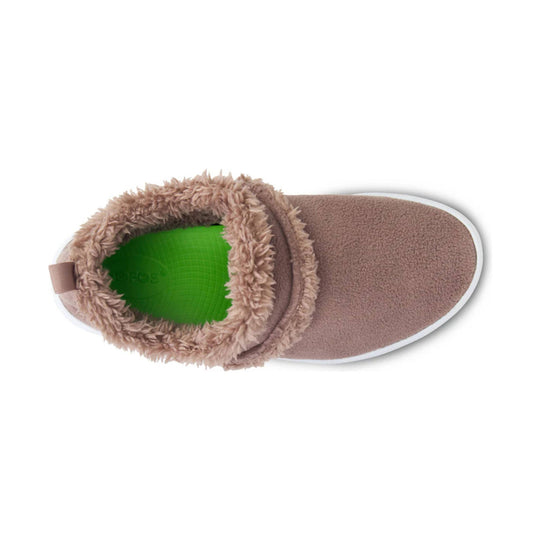 Fuzzy tan slip-on shoe viewed from above with a green insole and white sole