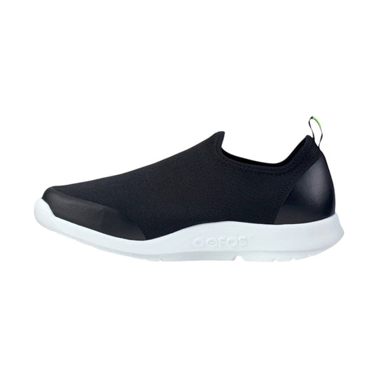Black slip-on shoe with a white sole and heel pull tab