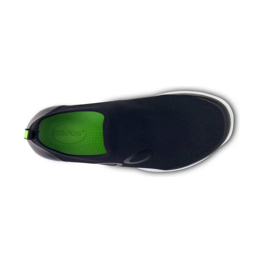 Black slip-on athletic shoe with a bright green insole, top view