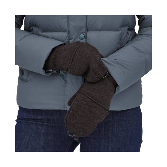 Dark brown knit fleece gloves worn with a blue puffer jacket and jeans