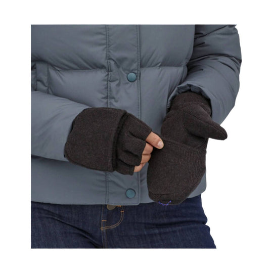 Dark knit mittens with fingerless cuffs worn with a gray puffer jacket