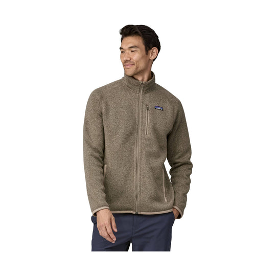 Brown zip-up fleece jacket with stand collar, chest logo patch, and zippered chest and hand pockets