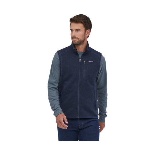 Navy fleece vest over a long-sleeve blue shirt, shown on a model against a white background