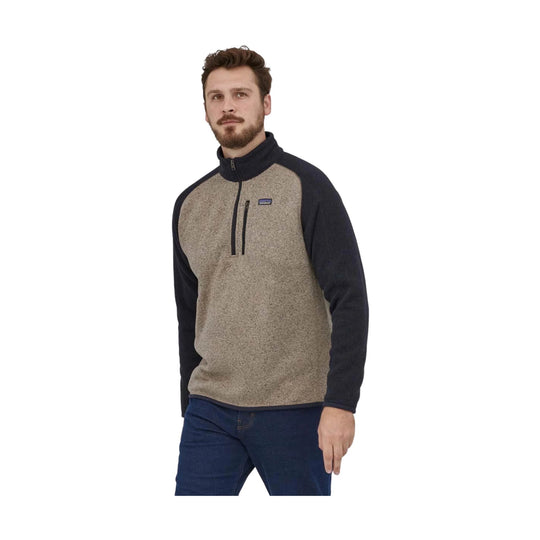 Men's half-zip fleece pullover with tan heather body and dark sleeves, shown on a model