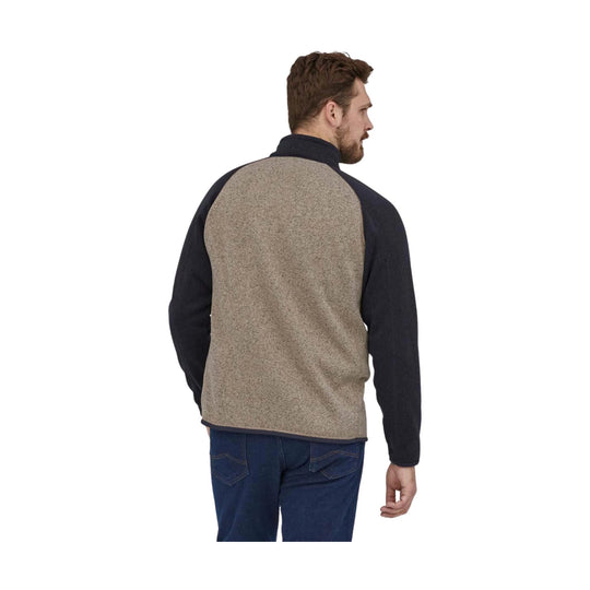 Heathered tan fleece pullover with navy sleeves, shown from the back