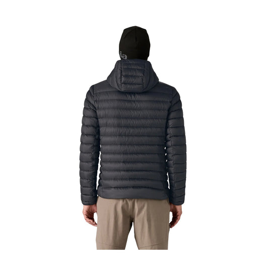 Black hooded puffer jacket shown from the back on a model