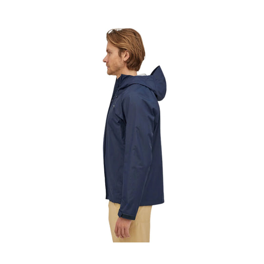 Navy hooded rain jacket shown in side view on a model