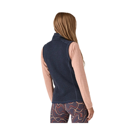 Women’s navy fleece vest over a long-sleeve top, shown from the back