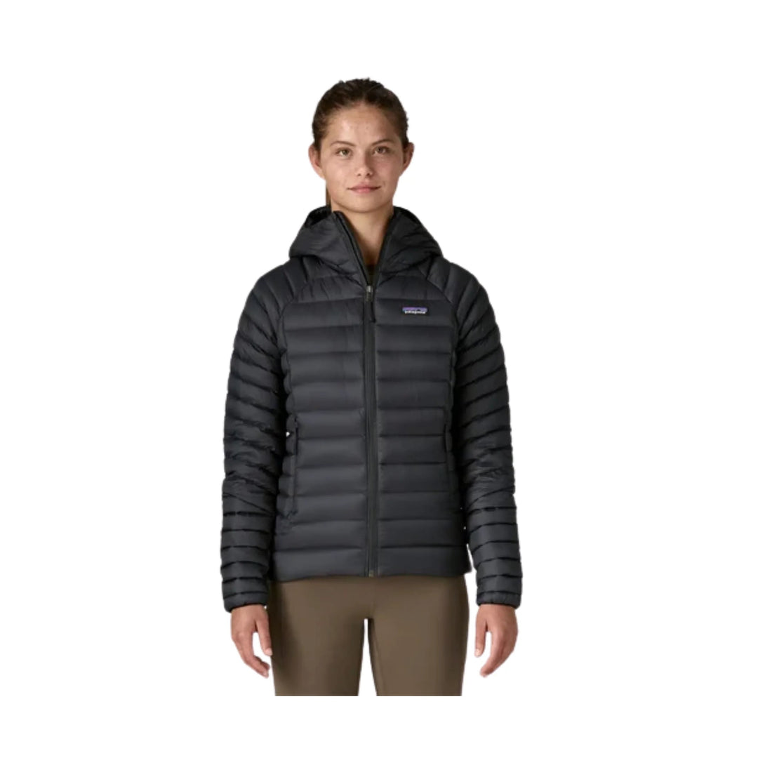 Black hooded quilted puffer jacket with front zipper on a model