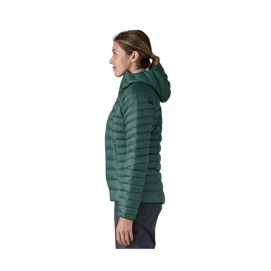Green hooded puffer jacket shown in side profile
