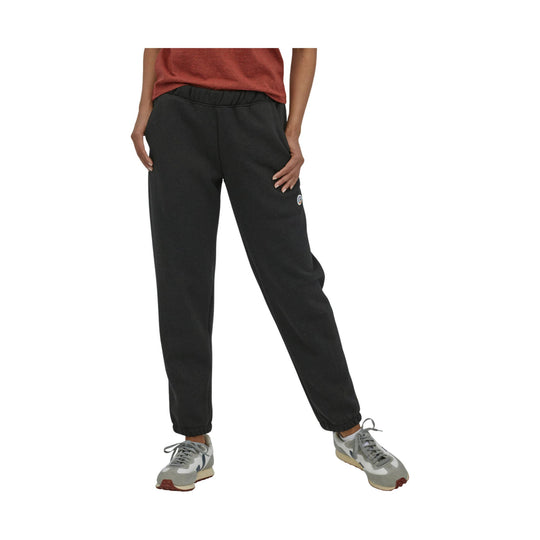 Black jogger sweatpants with elastic waist and cuffs, shown with a small leg logo