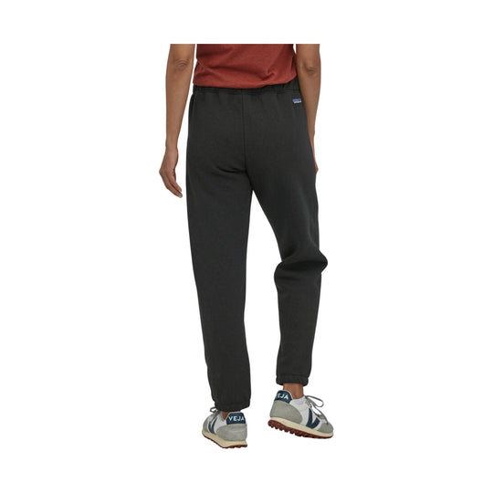 Black cuffed sweatpants shown from the back on a model