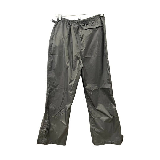 black rain pants hanging on a white background