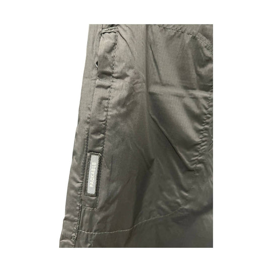 Close-up of a dark gray jacket with a brand label on a white background
