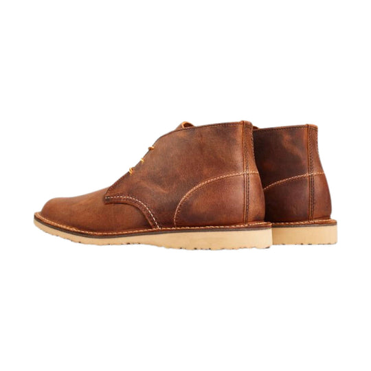 Brown leather chukka boots with light-colored soles, shown in side view
