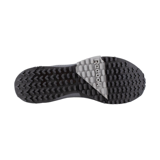 Black work shoe outsole with deep tread and a gray Reebok logo panel