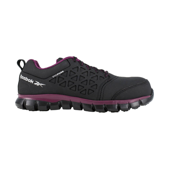 Black athletic work shoe with purple trim and a rugged lug sole, side view
