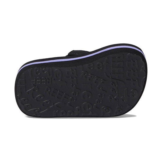 Black sandal sole with embossed pattern and a purple stripe along the edge