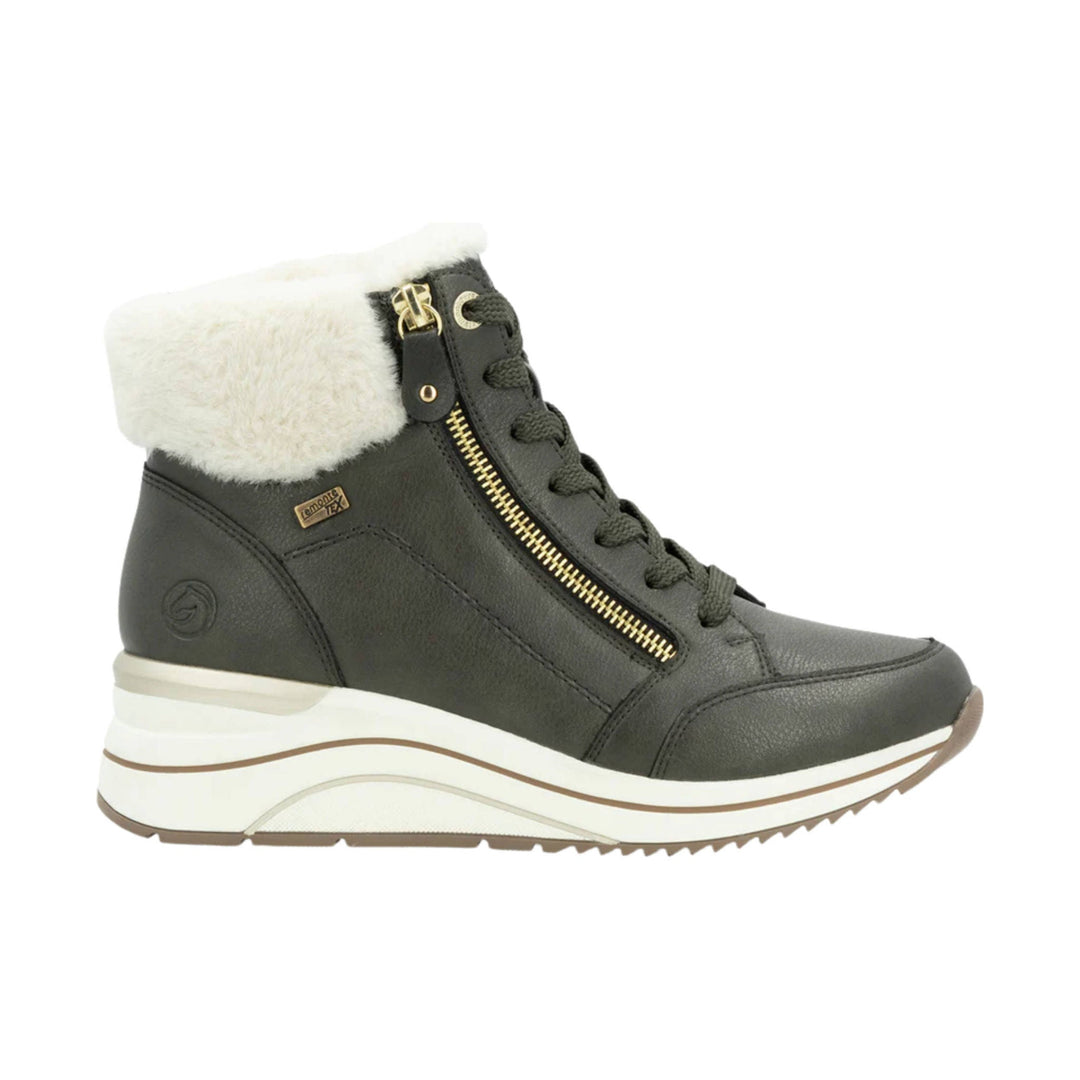 Dark ankle boot with faux-fur cuff, gold side zipper, and chunky white platform sole