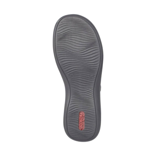 Dark gray shoe outsole with wavy tread and a pink rieker logo near the heel