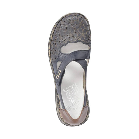 Dark blue closed-toe sandal with floral cutout toe box and crossover straps
