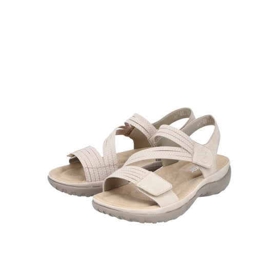 Beige women’s sport sandal with crisscross straps, slingback heel strap, and cushioned sole