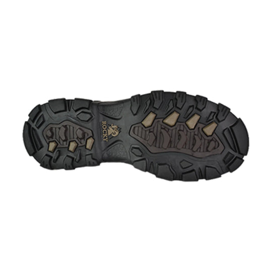 Black rugged boot outsole with deep tread and tan traction inserts, showing Rocky logo