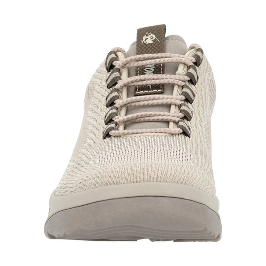 Light beige knit athletic shoe with bungee laces and a thick gray sole, shown from the front.