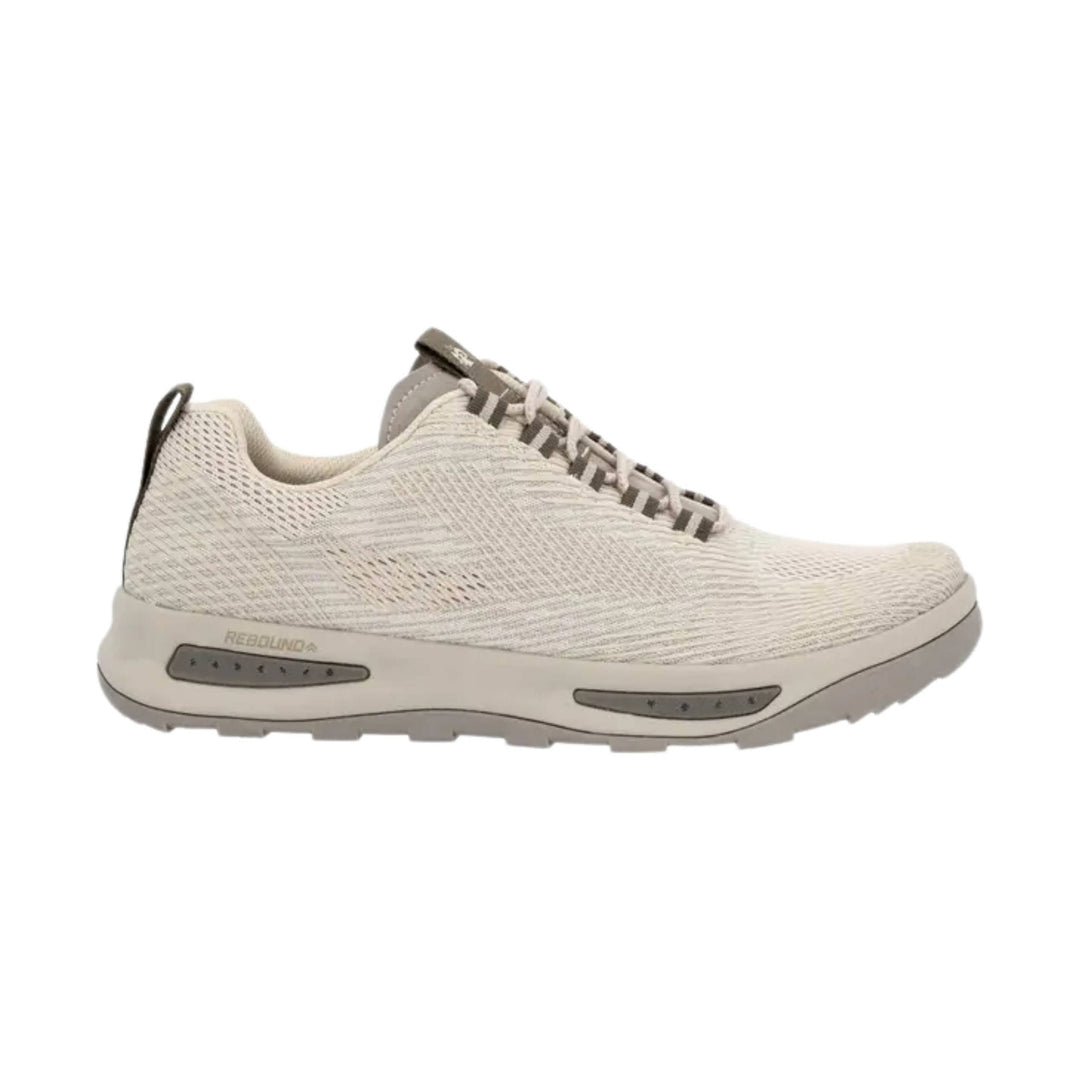 Light beige knit athletic shoe with striped laces, cushioned midsole, and visible side text