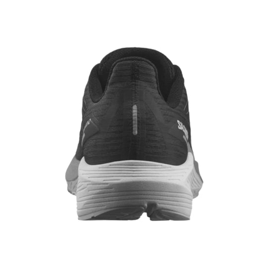 Black running shoe shown from the heel with a white cushioned midsole and reflective rear tab