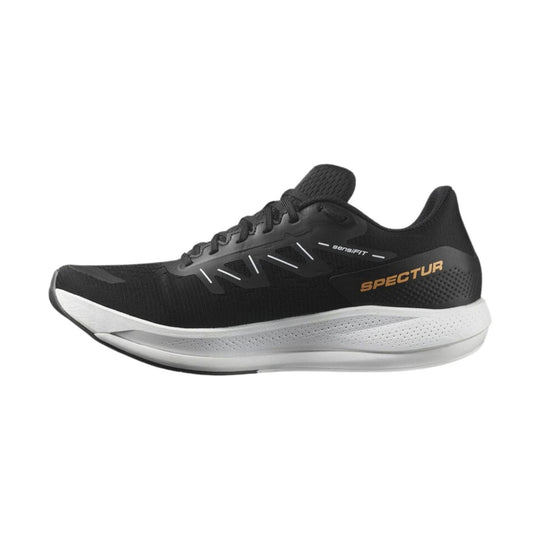 Black running shoe with white midsole, orange side logo, and lace-up upper