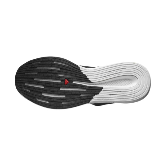 Black and white running shoe outsole with red triangular logo