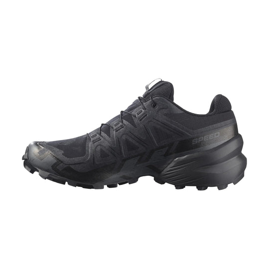 Black trail running shoe with lugged sole and side branding