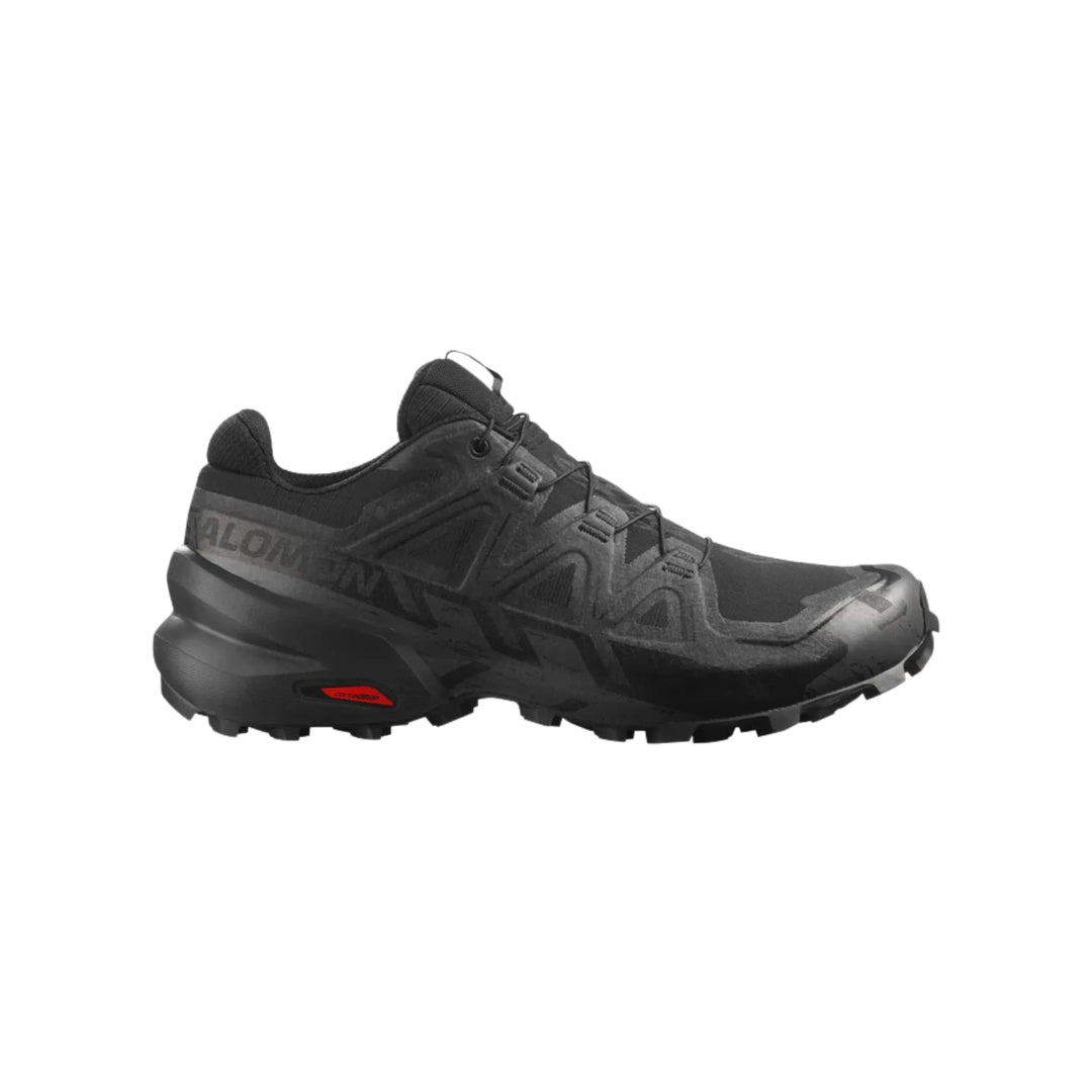 Black trail running shoe with lugged sole, quick-lace system, and side branding