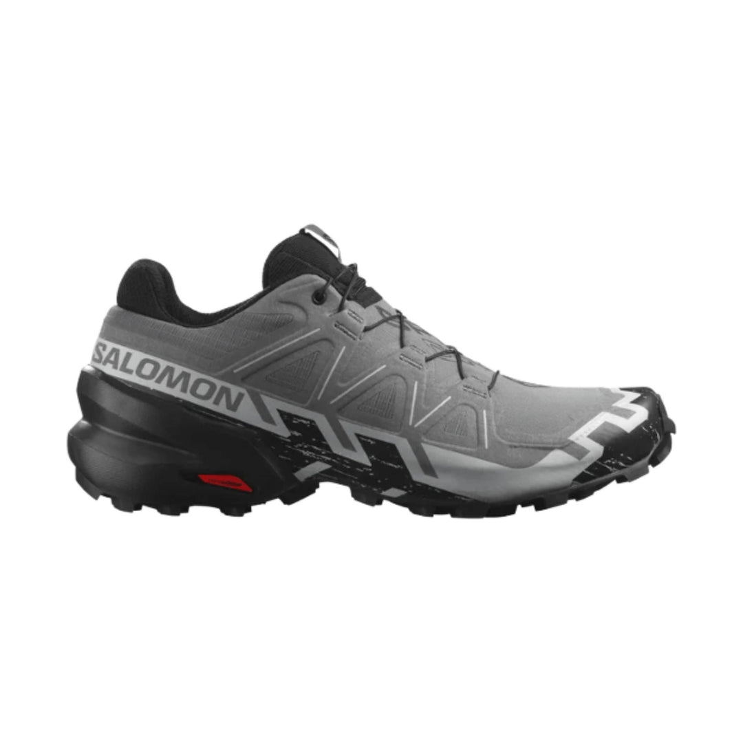 Gray and black trail running shoe with lugged sole and large SALOMON branding on the side