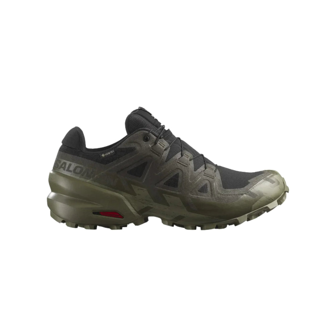 Low-top black and olive hiking shoe with lugged sole and visible Salomon branding