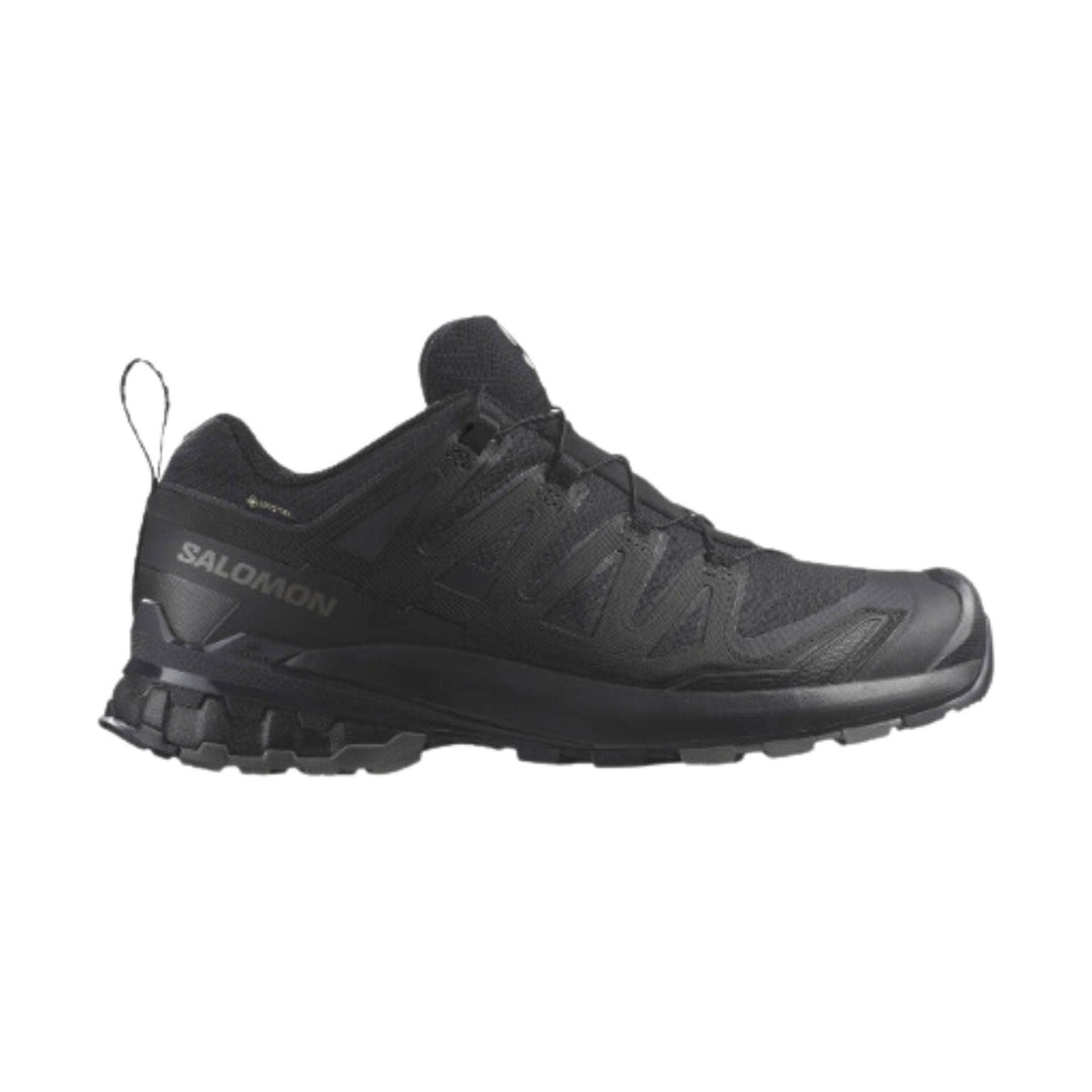 Black trail running shoe with a rugged lugged sole and side "SALOMON" branding