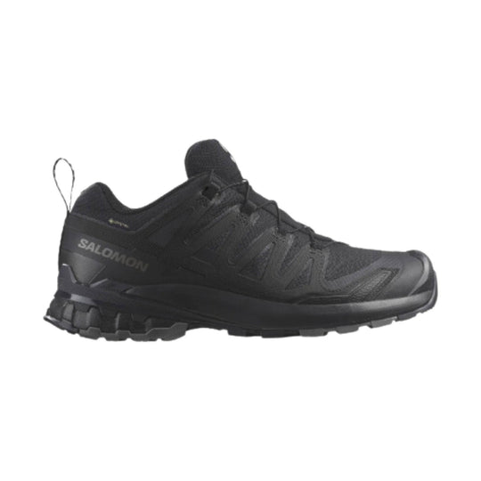 Black trail running shoe with a rugged lugged sole and side "SALOMON" branding