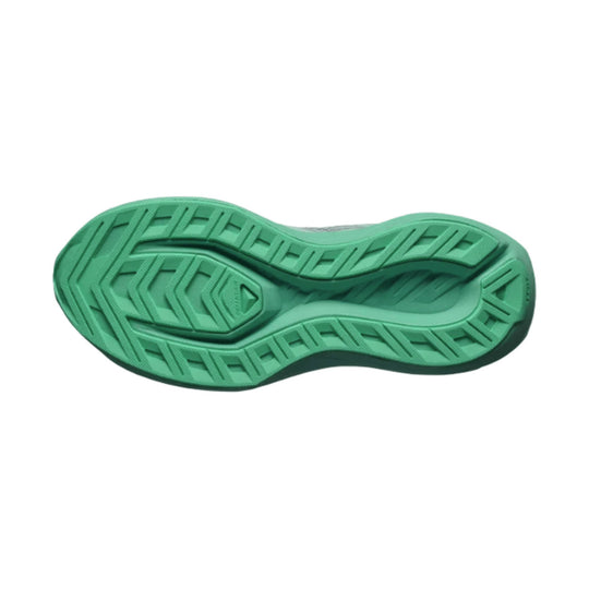 Green running shoe outsole with deep tread pattern and curved midfoot cutout