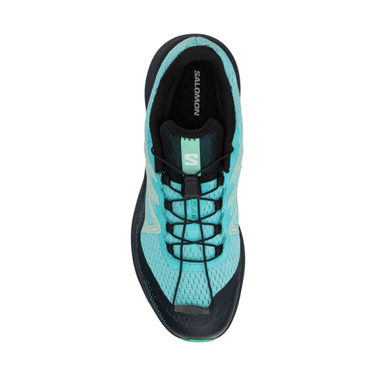 Top view of a turquoise and black trail running shoe with bungee laces and Salomon branding