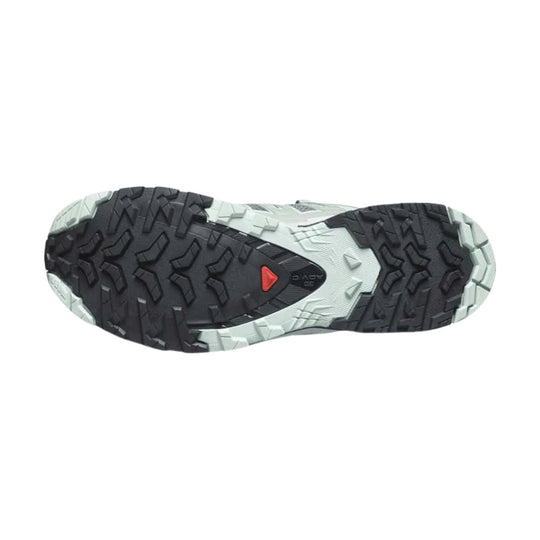 Trail running shoe outsole with black lugs and light gray midsole details