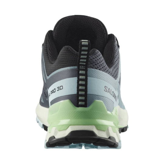 Rear view of a black, gray, and pale green trail running shoe with a chunky sole and heel pull tab