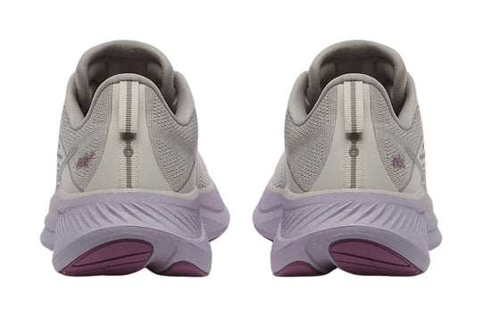 Light gray running shoes with purple outsoles, shown from the back
